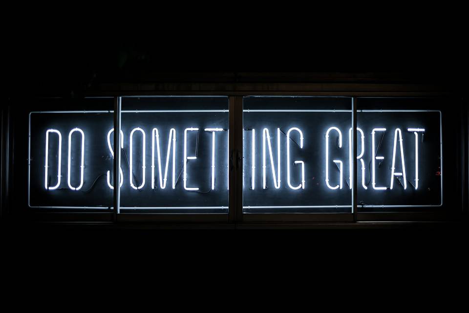 Neon sign letters saying: "Do something great"