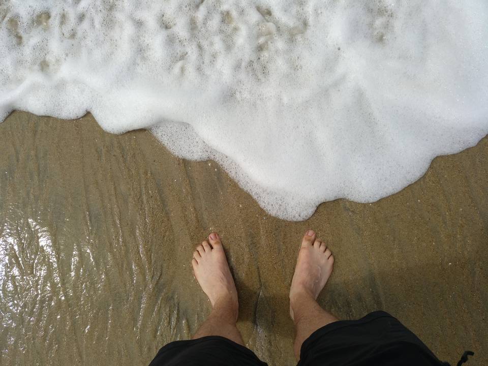My feet in the foamy surf