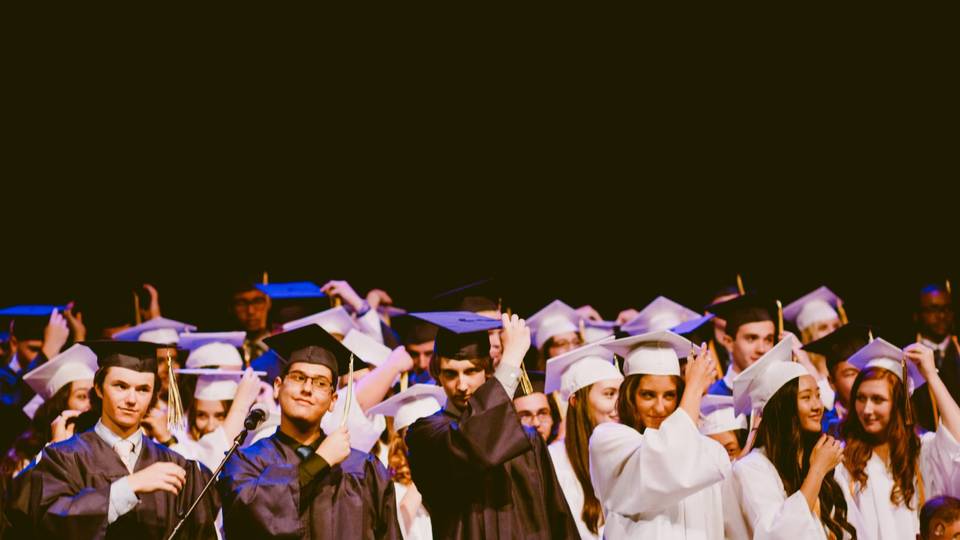 Graduates about to throw their heads in the air