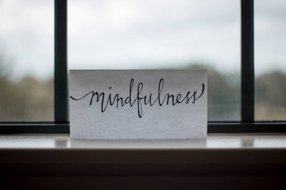 Paper note with "mindfulness" in handwriting.