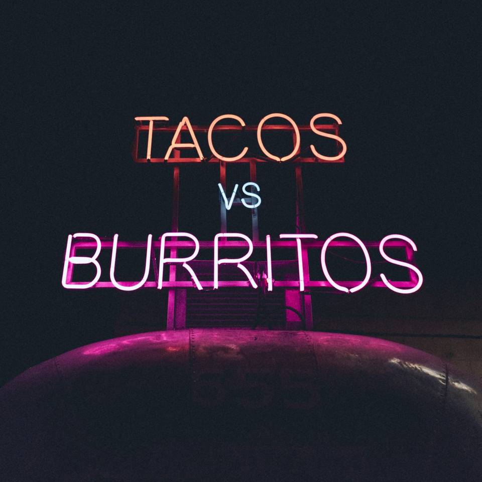 Neon sign: "Tacos vs Burritos"