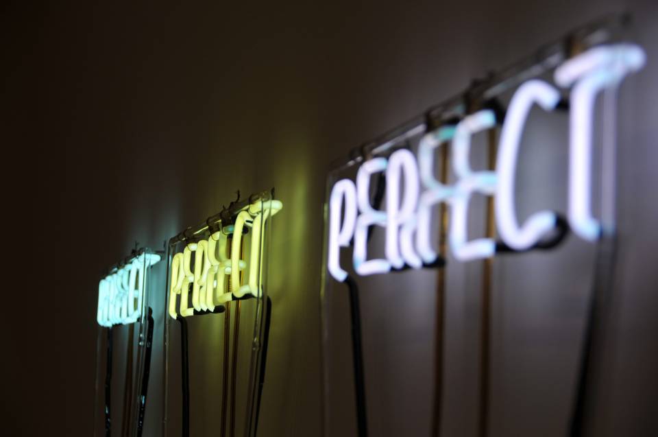 Neon sign of the word perfect. Not perfection, but good enough.