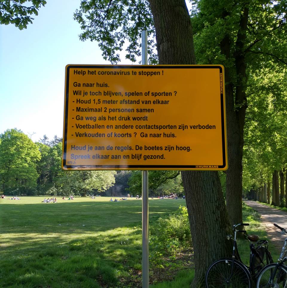 sign in the park warning about covid