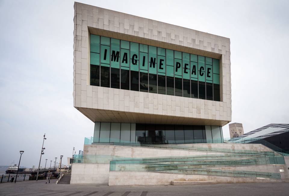 Building with sign on the windows saying: "Imagine Peace"