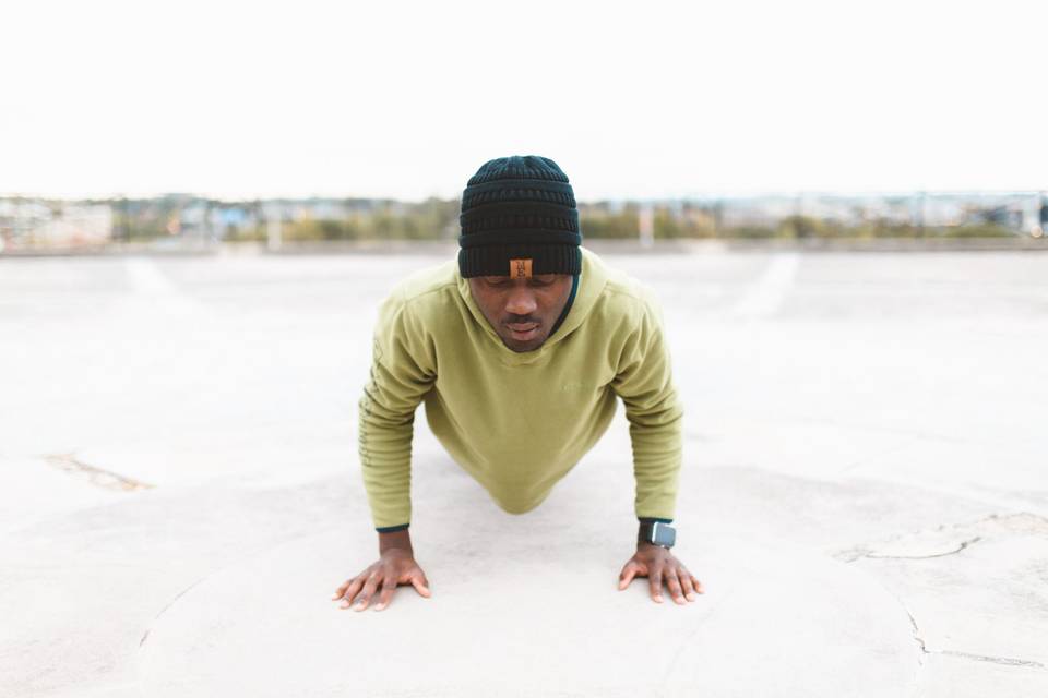 Man doing pushup outside in winter gear